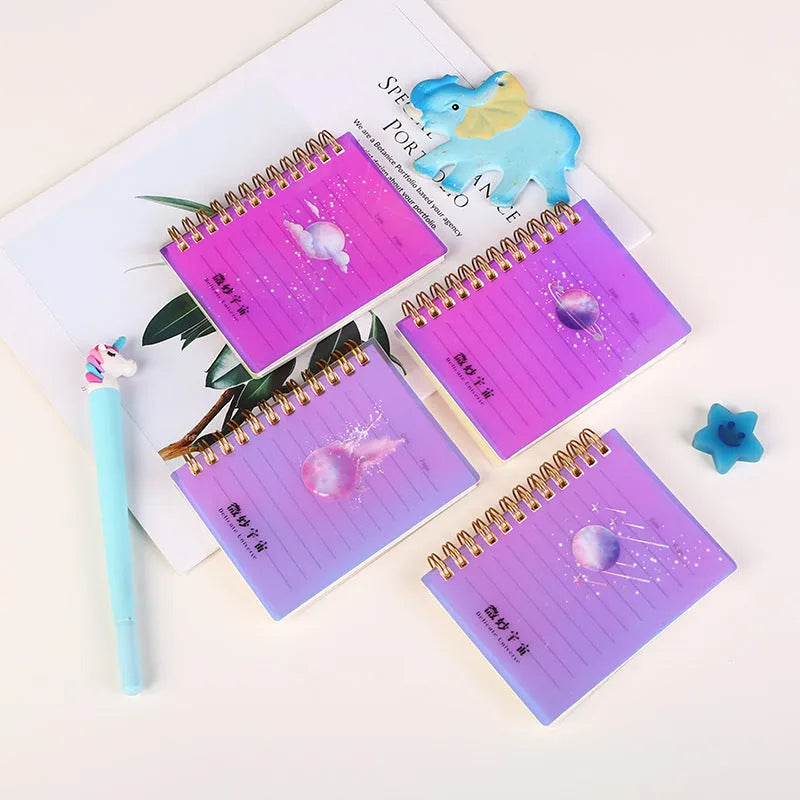 Set of four A7 spiral notebooks with different coloured PP plastic covers, showing spiral binding and open page.