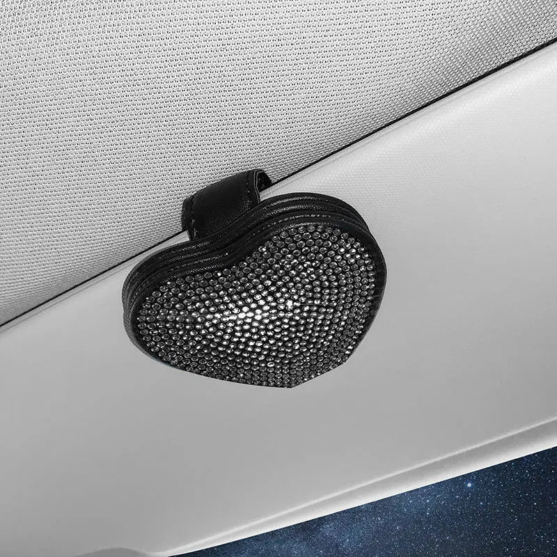 Black diamond-encrusted PU leather magnetic storage clip for car sun visor, holding sunglasses.