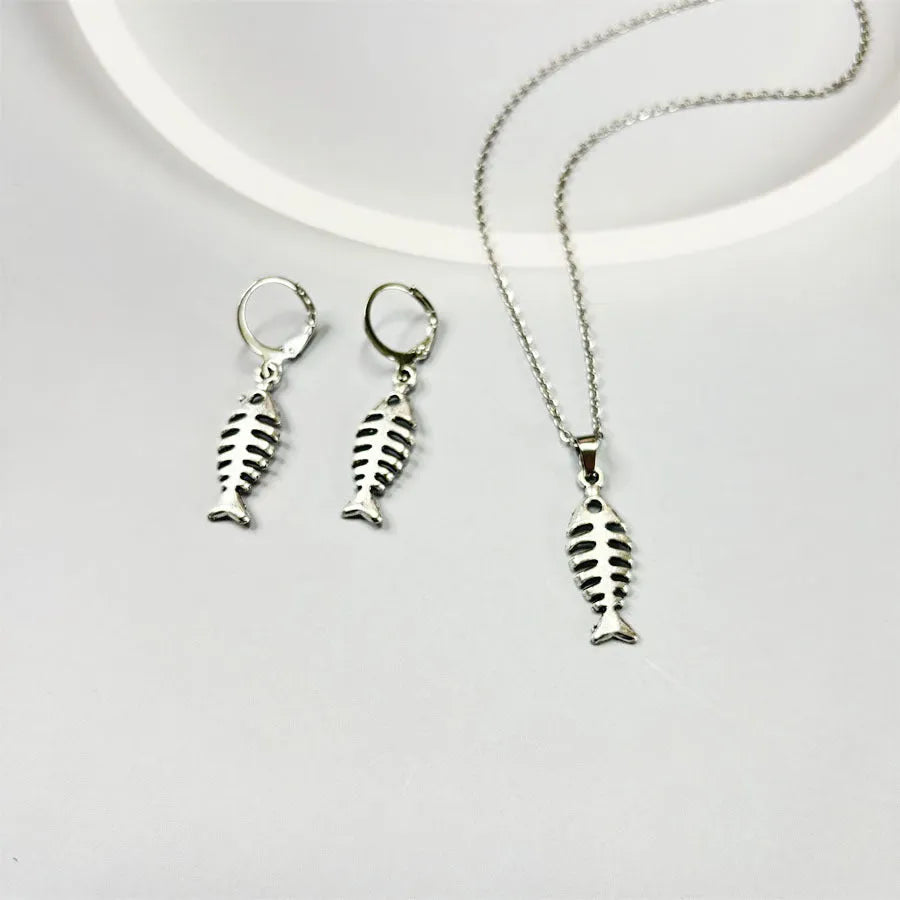 Fishbone pendant necklace and earrings set with adjustable chain on white background