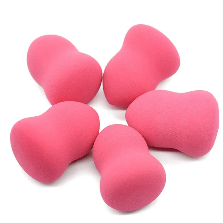 Pink teardrop makeup blending sponge on a plain background.