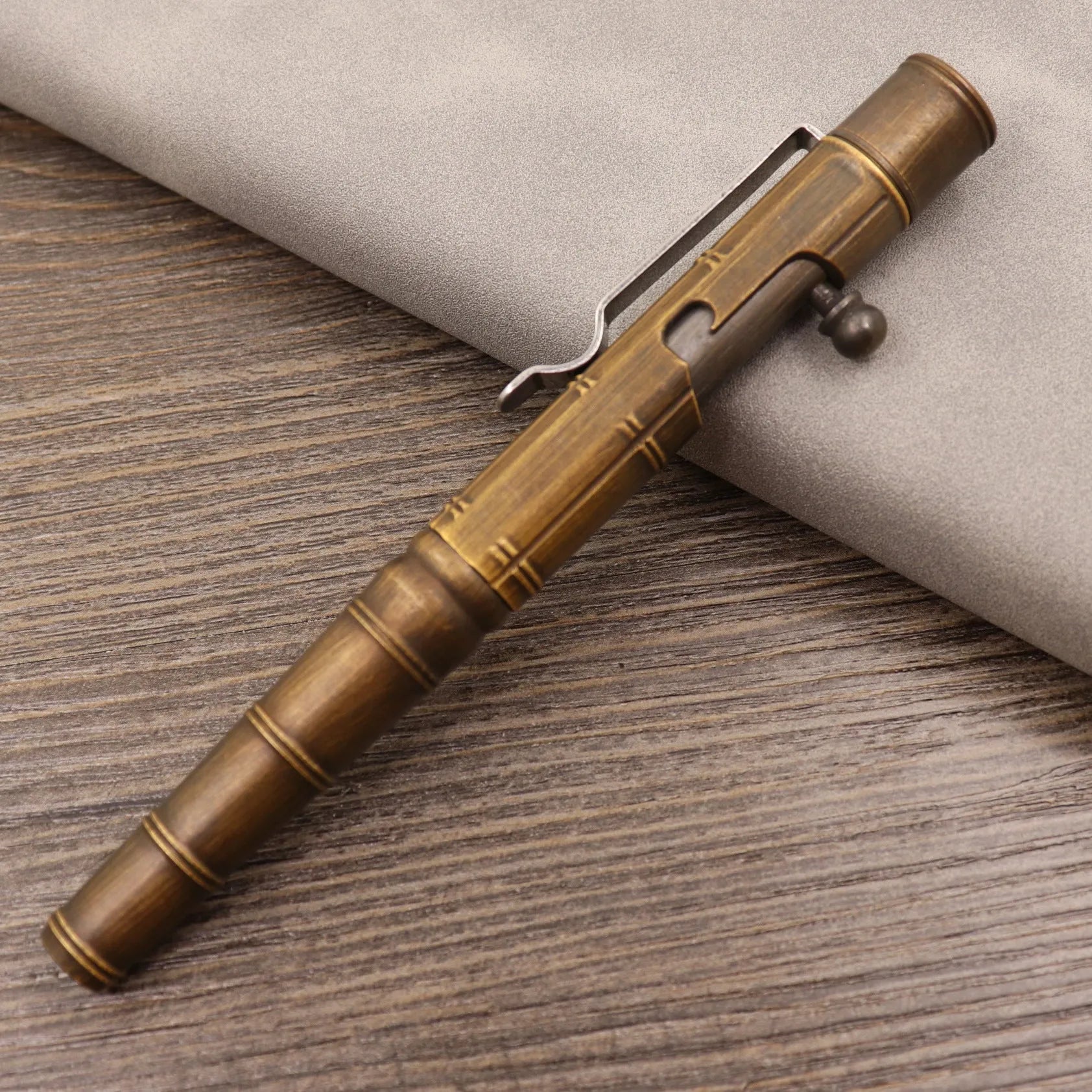 Retro brass tactical pen with bolt action mechanism in brushed natural finish