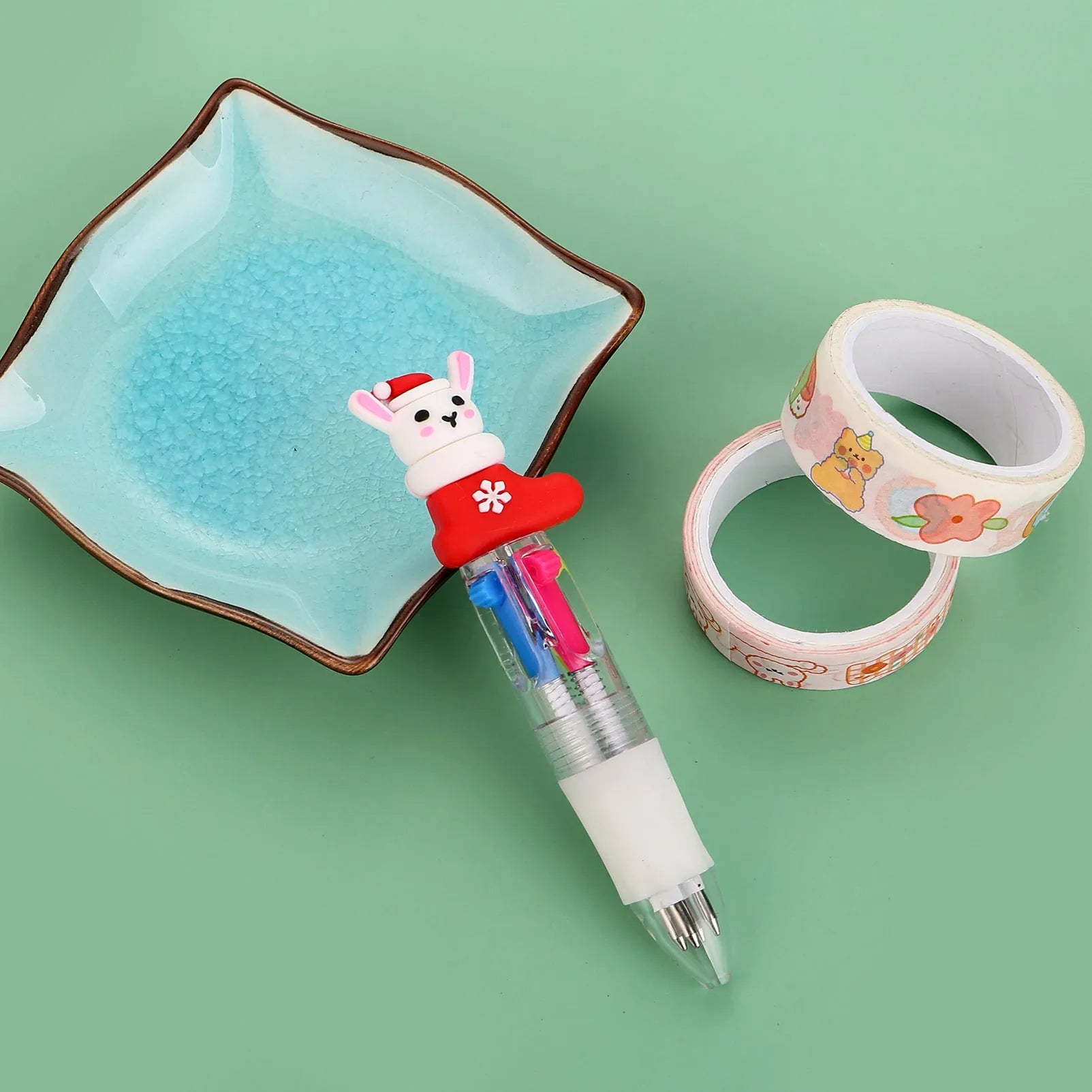 Compact 11cm Christmas four-colour press pen with festive designs including reindeer and snowmen.