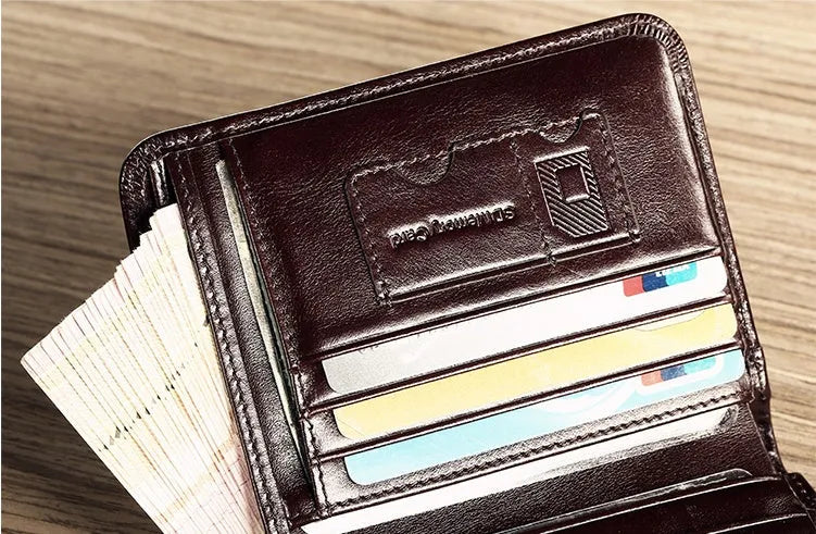Men's black leather bifold wallet open to show internal card slots, photo window, coin pocket, and banknote compartment.