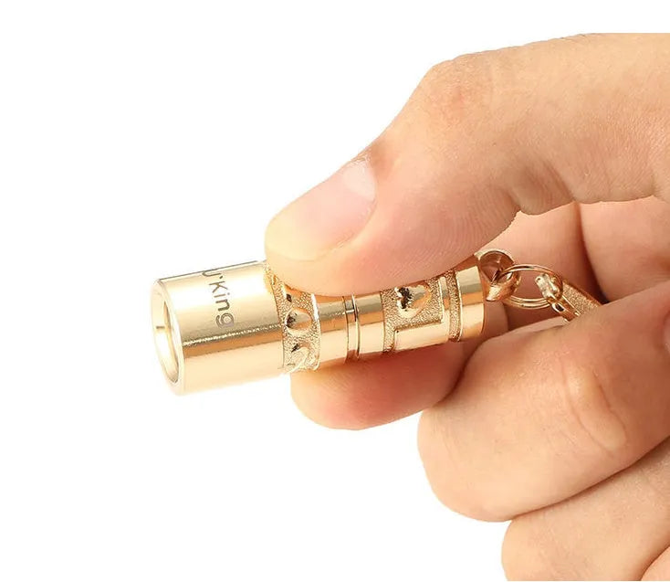 Gold zinc alloy waterproof LED flashlight attached to a keychain.