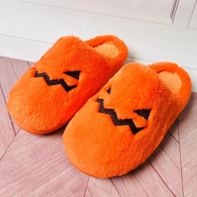 Orange women's pumpkin-themed plush slippers with a coral velvet upper and a flat non-slip sole.