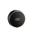 Black automatic touchless foam soap dispenser mounted on a wall with USB charging cable.