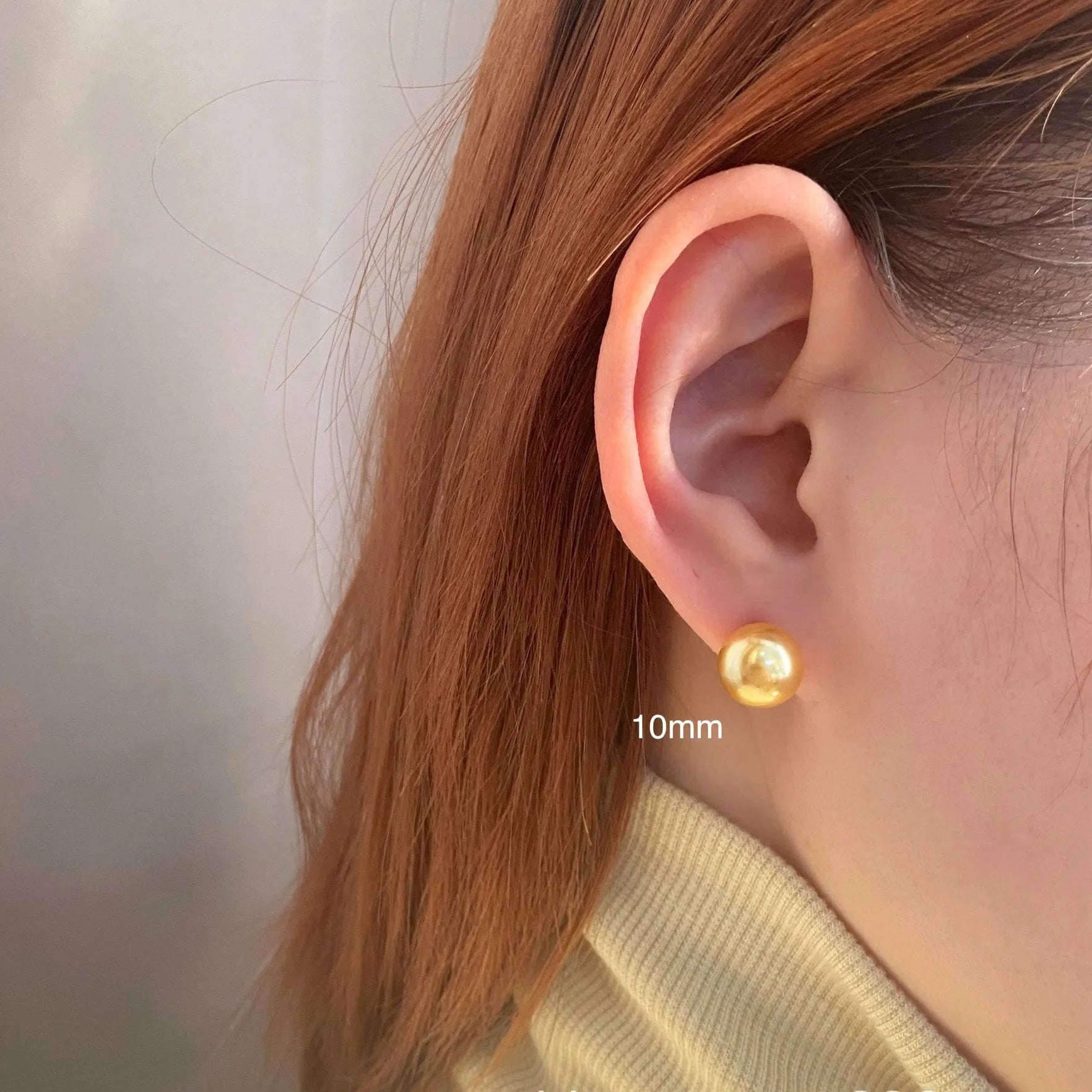 A pair of large geometric pearl stud earrings with an eight-point star detail on silver settings.