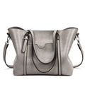 Retro messenger bag for women showing large main compartment and shoulder strap