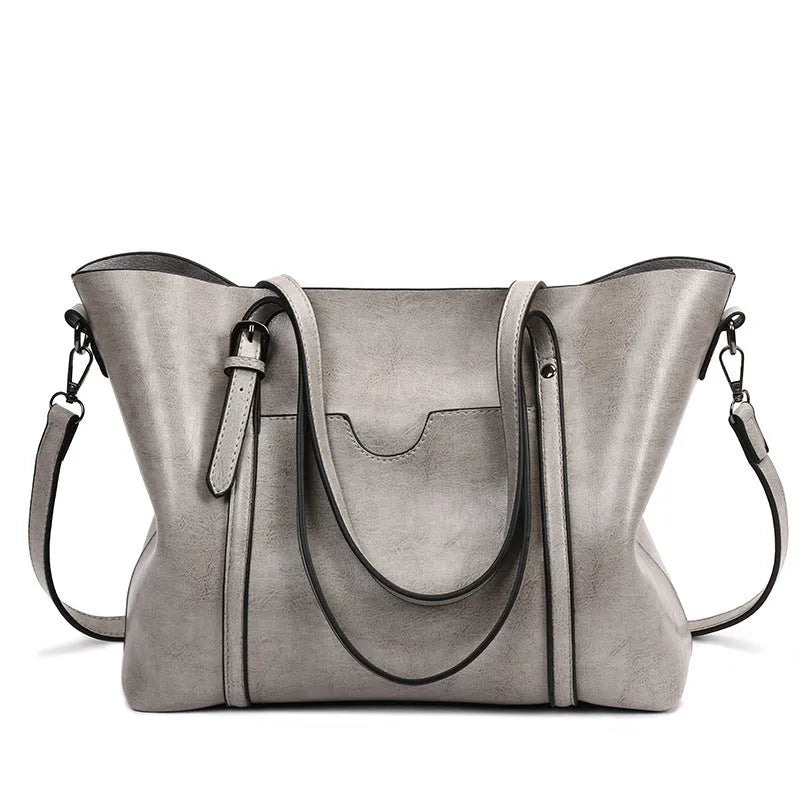 Retro messenger bag for women showing large main compartment and shoulder strap