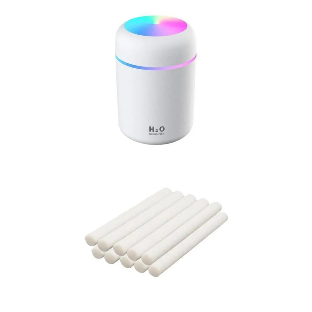 Pink USB desktop humidifier with coloured lights and water tank on a wooden desk