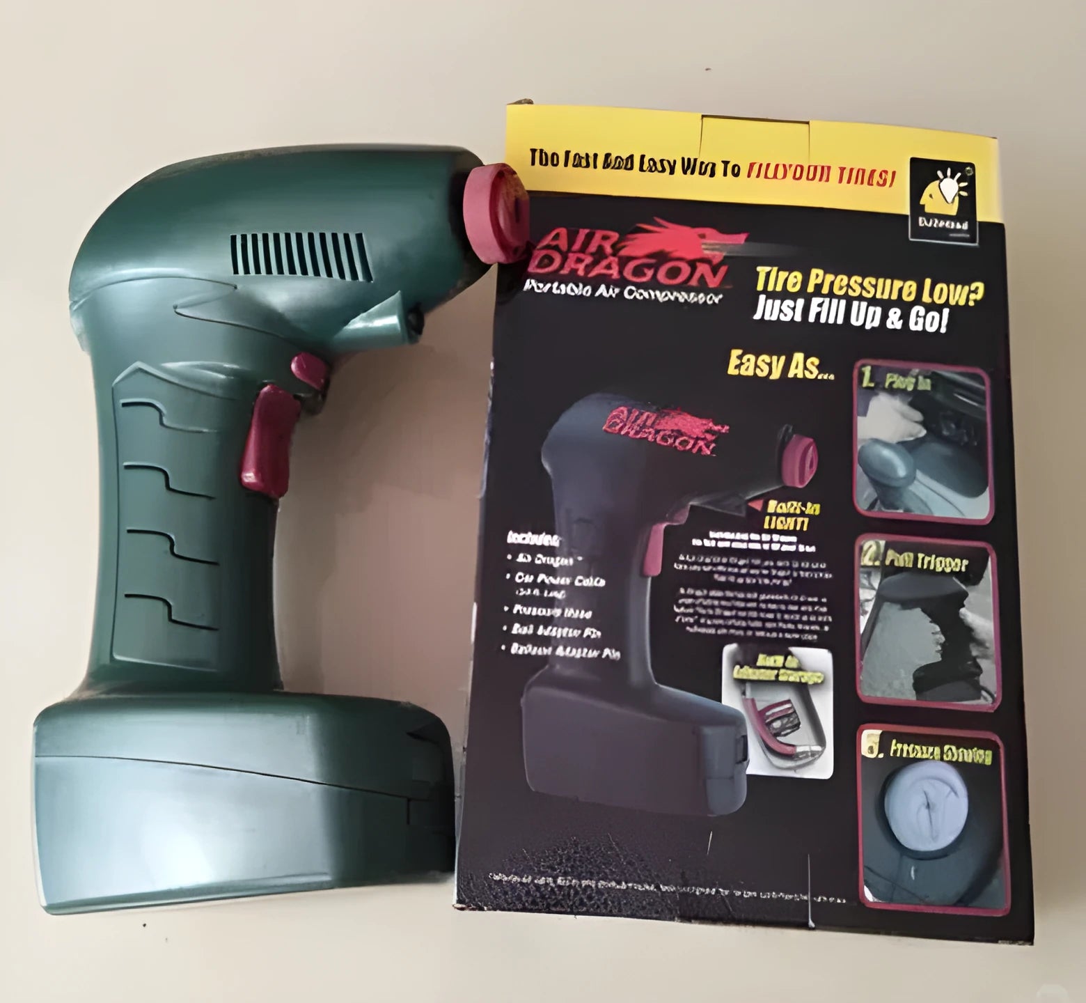 Compact black 12V portable car tyre inflator with motor and air hose for emergency use.