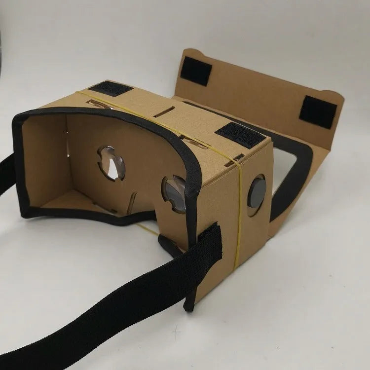 Pink and white cardboard VR headset for smartphones with adjustable strap and magnetic button.