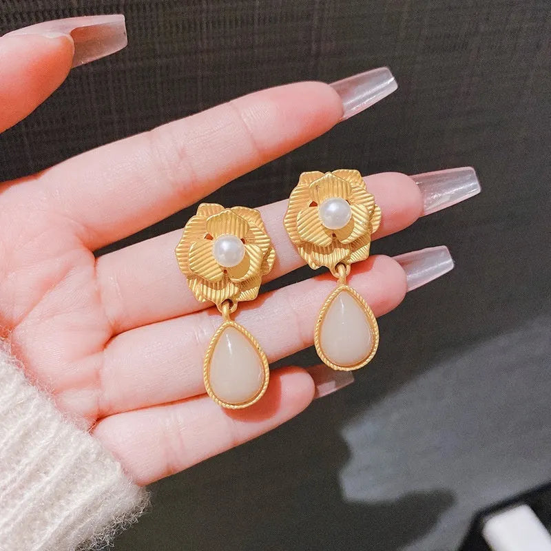 Gold-toned stud earrings with Hong Kong style ice flower design and centre opal stone