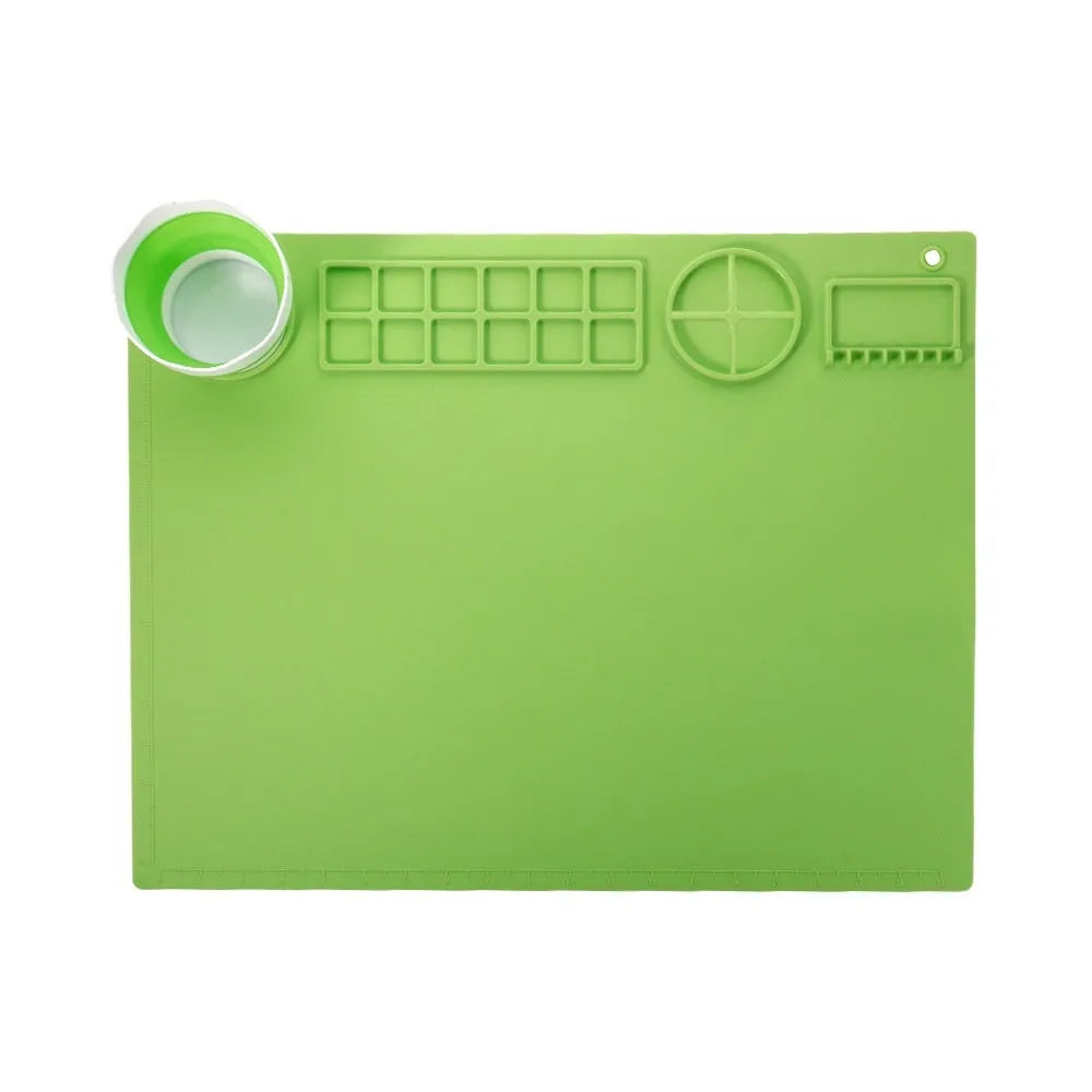 Green silicone painting mat measuring 50x40cm with two round paint mixing bowls on the surface.