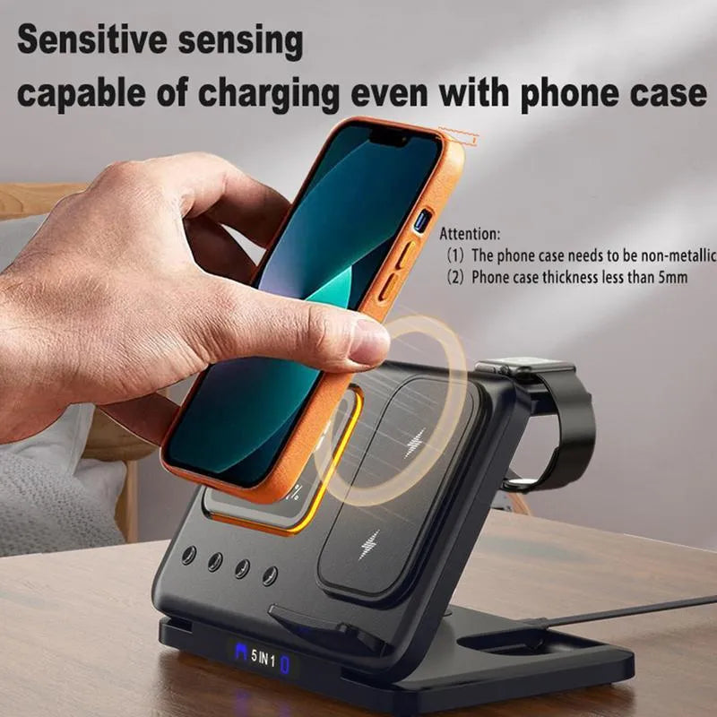 Black and white wireless charging dock station with digital clock display, charging a phone, watch, and headphones.