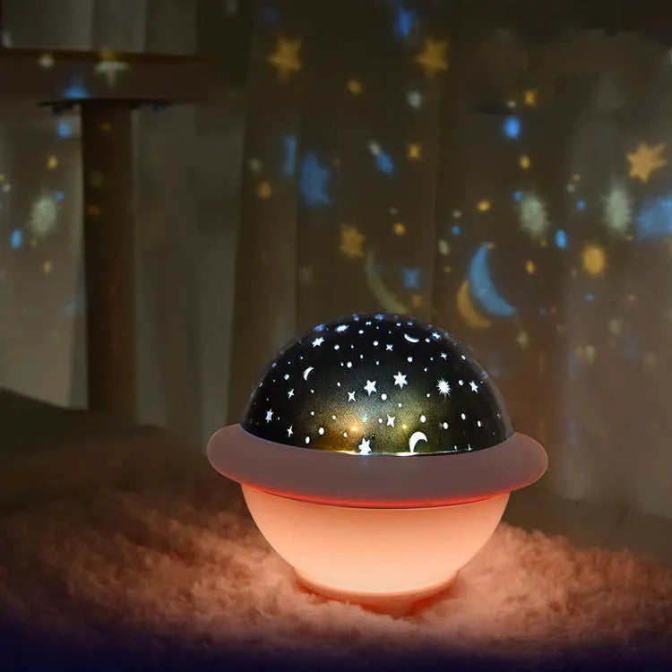 UFO-shaped starry sky projection night light in pink, white or green on a surface