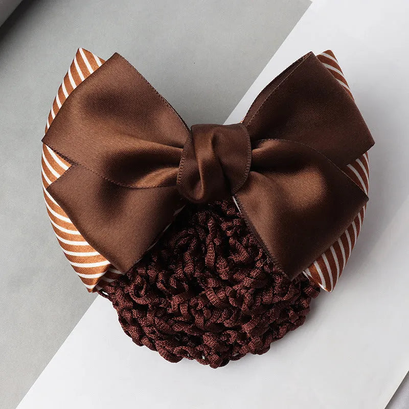 Professional flower bow headdress hair clip ornament on a work plate, shown in a selection of net and mesh colour variations.