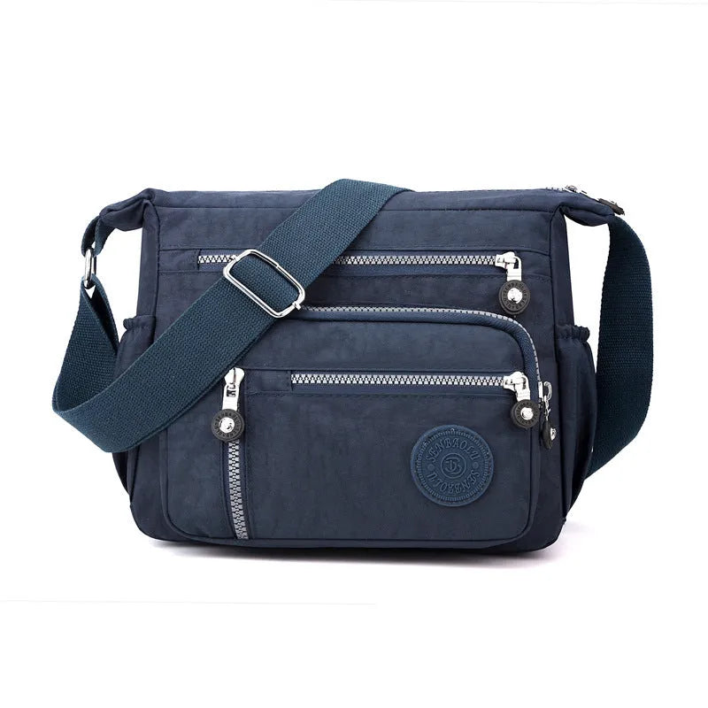 Nylon messenger bag in grey colour with single shoulder strap and square vertical design