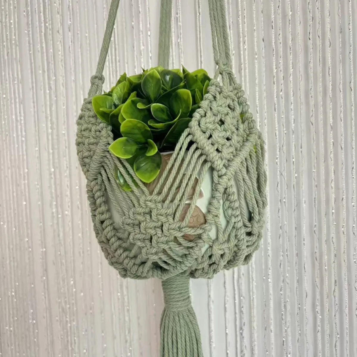 Hand-woven brown polyester cotton flower pot cover with a net pocket on the side.