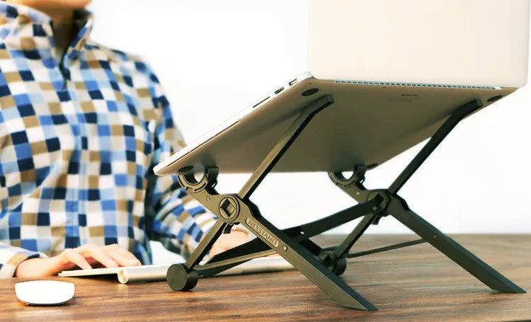 Black folding portable laptop stand made of reinforced nylon, shown both open for use and folded flat.
