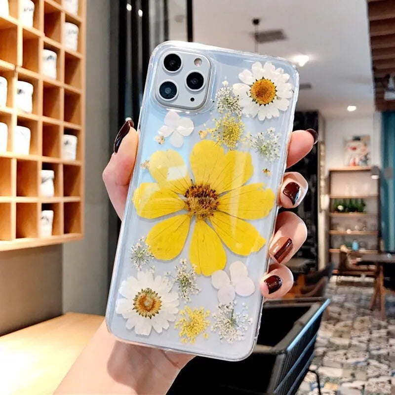 Floral pattern iPhone case in pink or yellow colour on a mobile phone