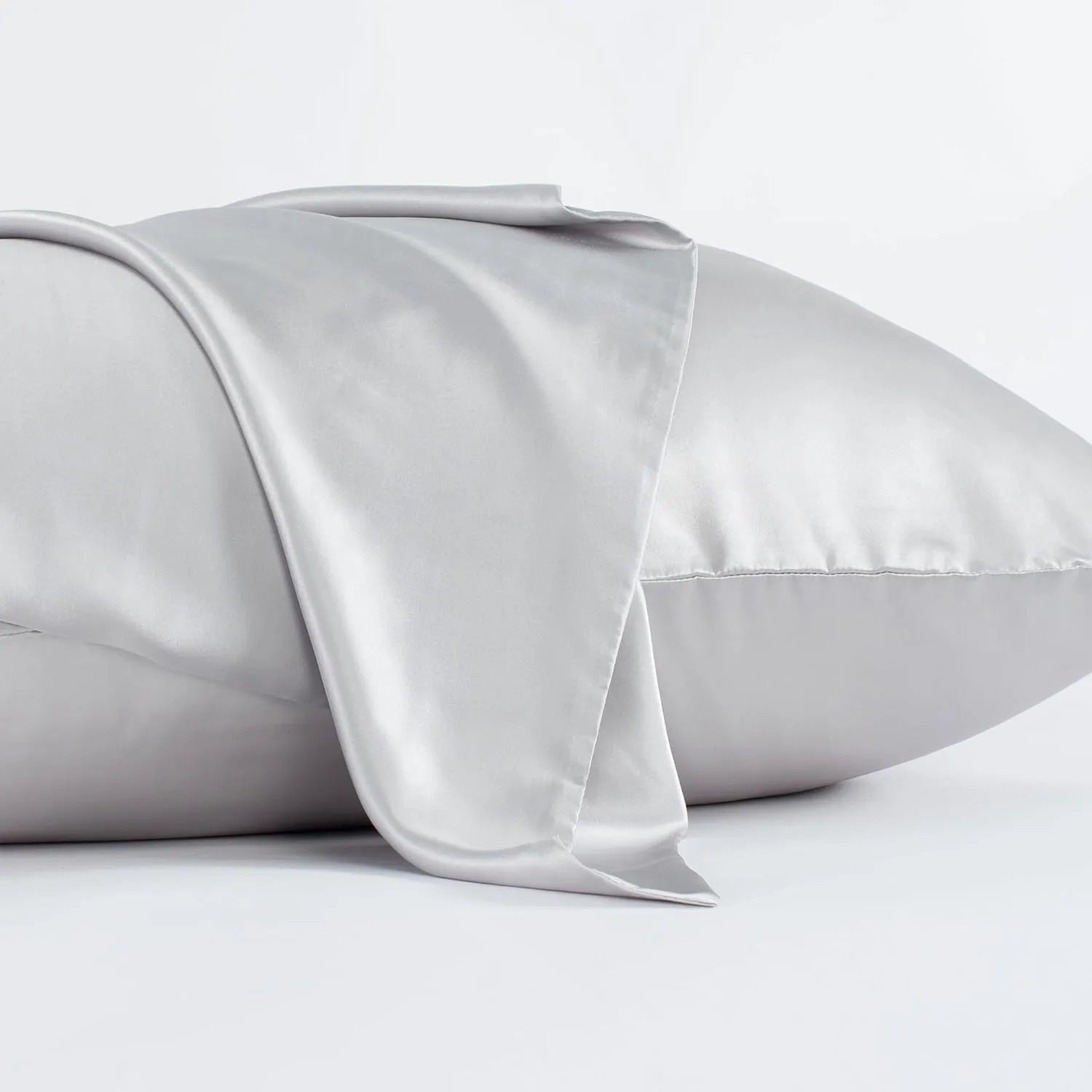 Dark gray envelope closure silk pillowcase on a bed