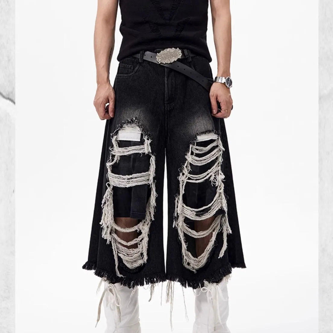 Black women's cropped wide-leg jeans with a mid-high waist and ripped patch distressing.