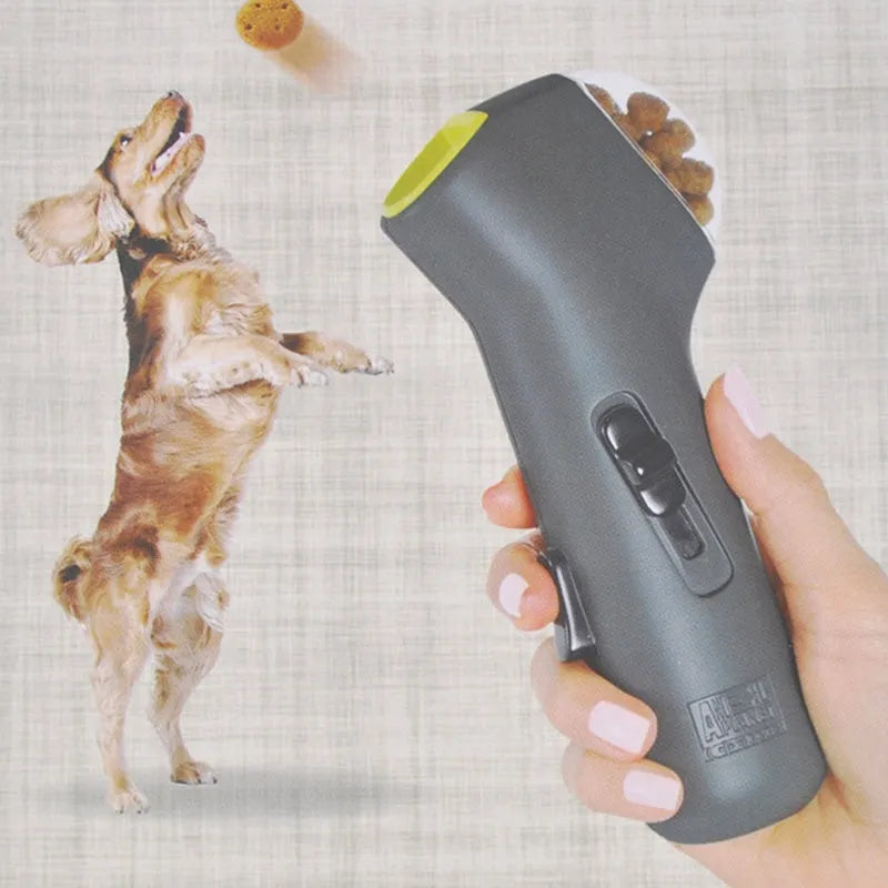 Grey plastic pet snack catapult launcher toy on a plain background.