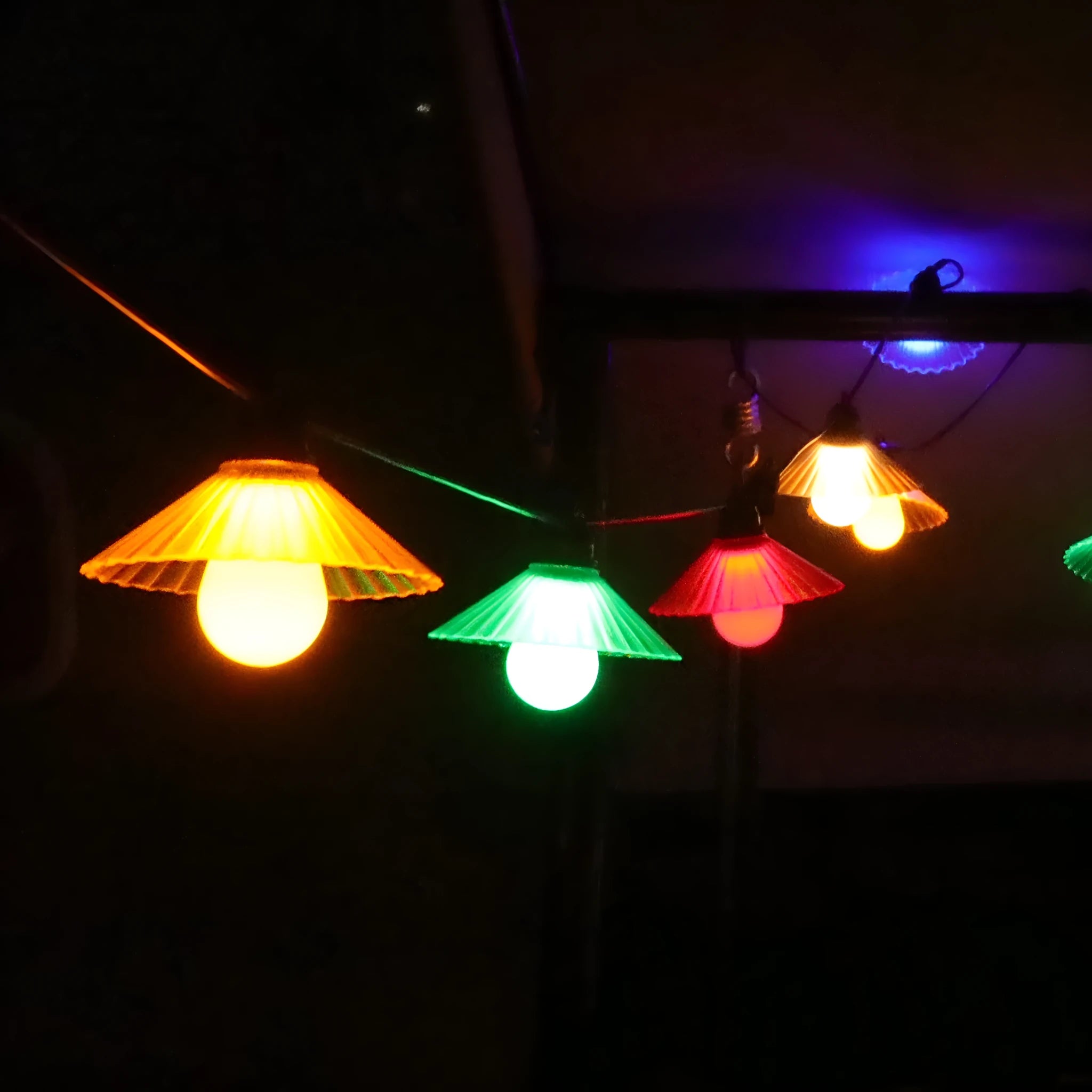 Outdoor waterproof LED string lights with flower-shaped globes in warm white and multi-colour options.