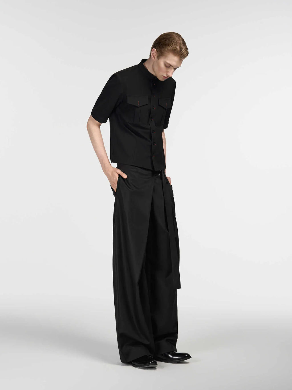 Black loose fit straight-leg trousers with adjustable waistband and single pleat detail