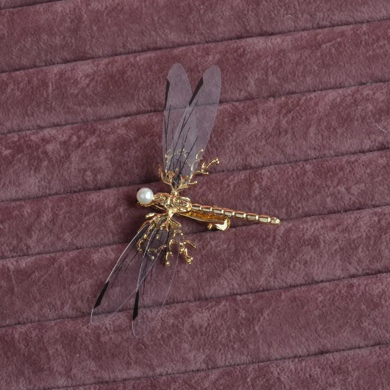 Golden dragonfly-shaped metal alloy headdress with a side clip for hair.