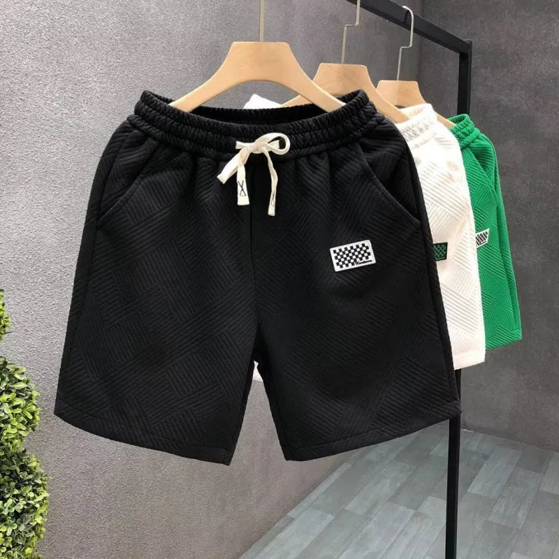 Casual solid colour sports shorts made from elastic polyester fabric.
