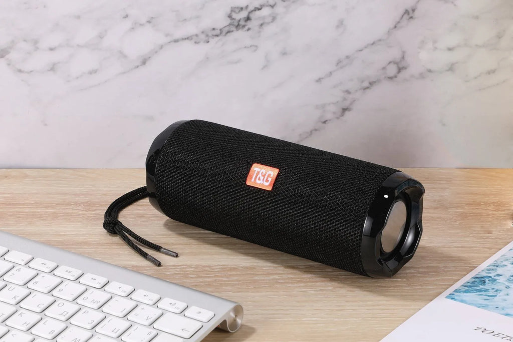 Fabric-covered portable Bluetooth speaker with integrated card holder in choice of colours.