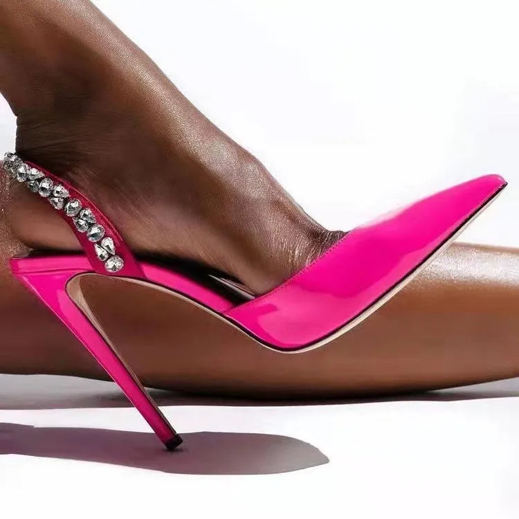 Women's pointed toe high heel sandals with rhinestone detail on patent leather upper.
