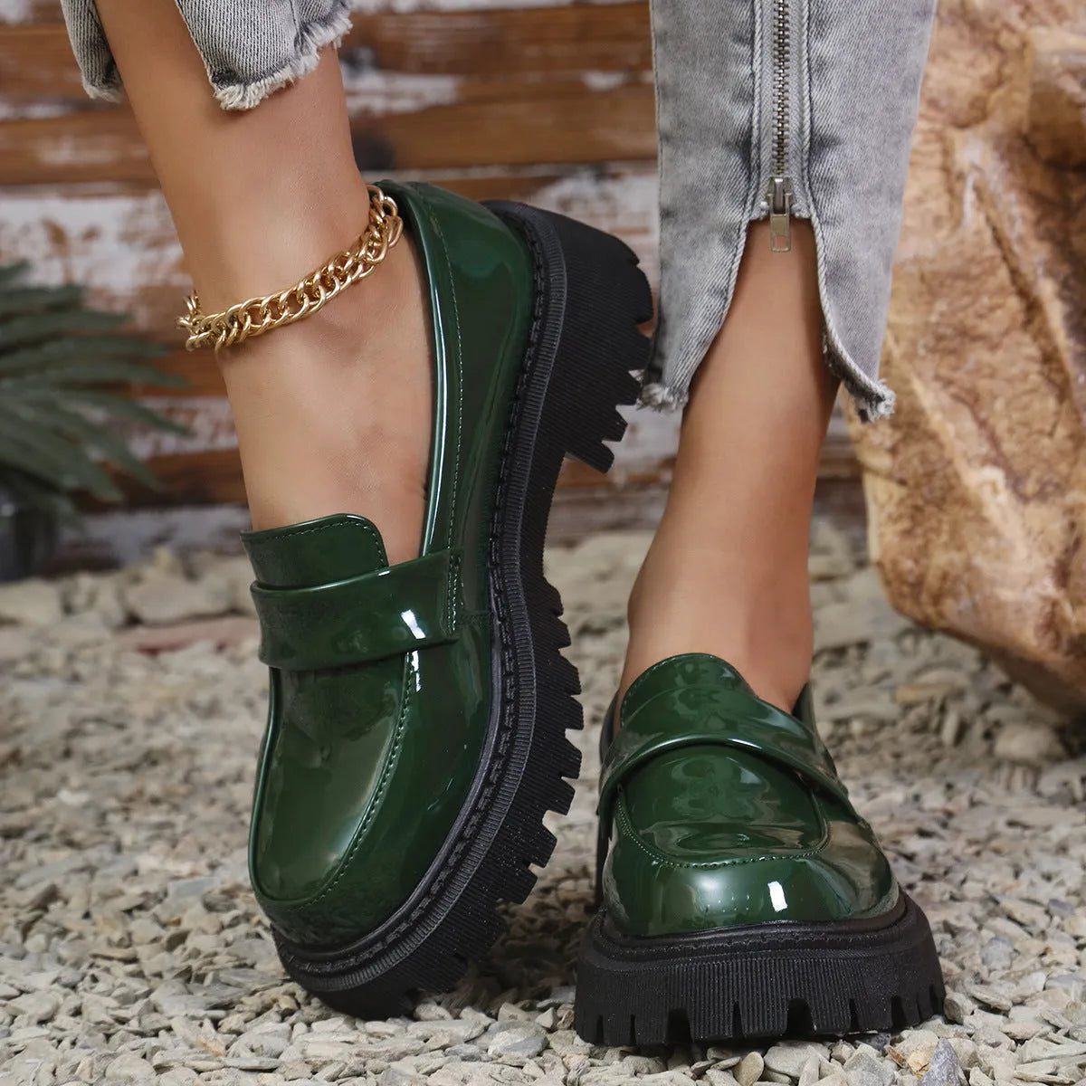 Plus size black slip-on loafers with a chunky platform heel and thick rubber sole.