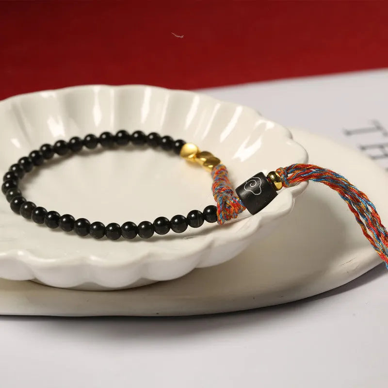 Hand-woven obsidian carrying strap showing texture and 4mm width