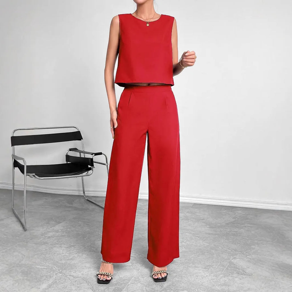 Red two-piece set with sleeveless round neck top and wide-leg trousers laid flat