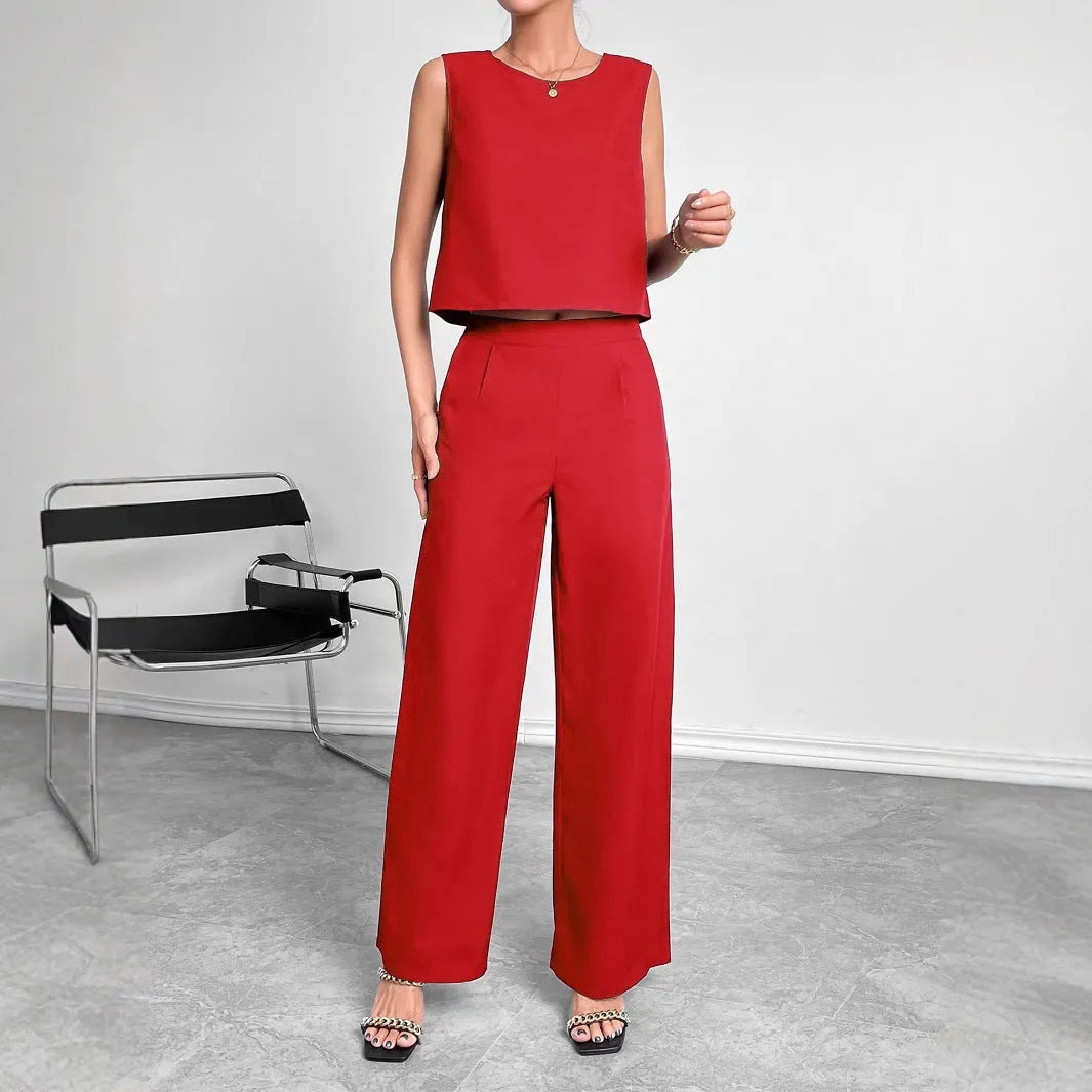 Red two-piece set with sleeveless round neck top and wide-leg trousers laid flat