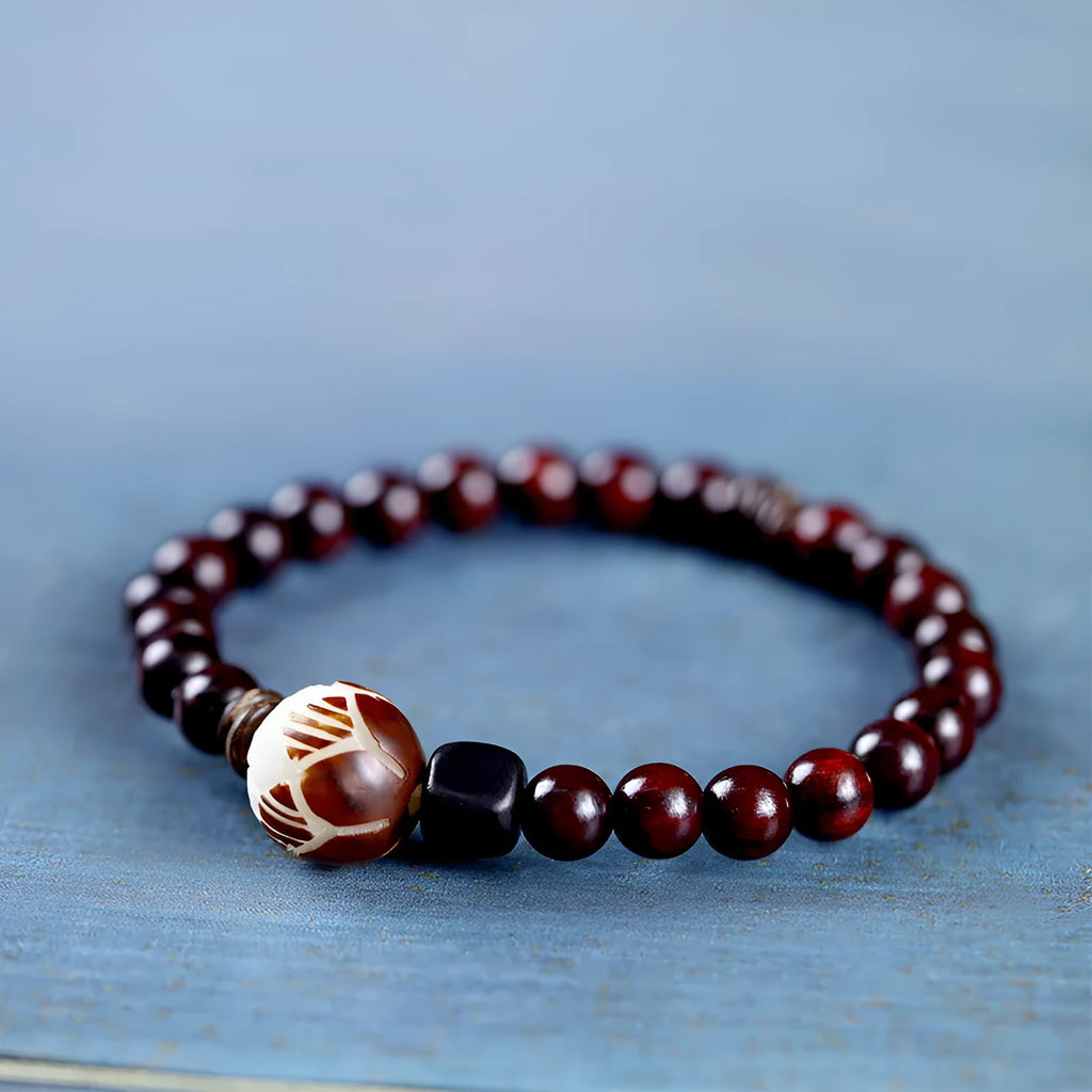 Rosewood bracelet with floral bead and knitted construction showing natural wood texture