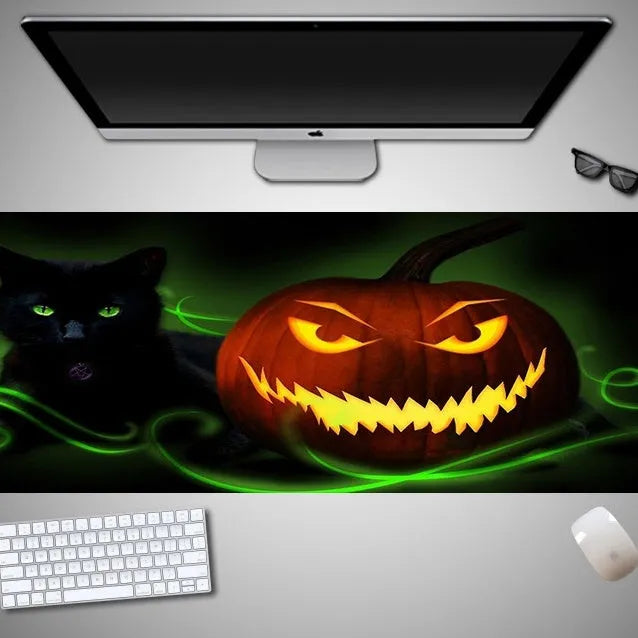 Oversized Halloween-themed computer mouse pad with non-slip rubber cloth base on a desk