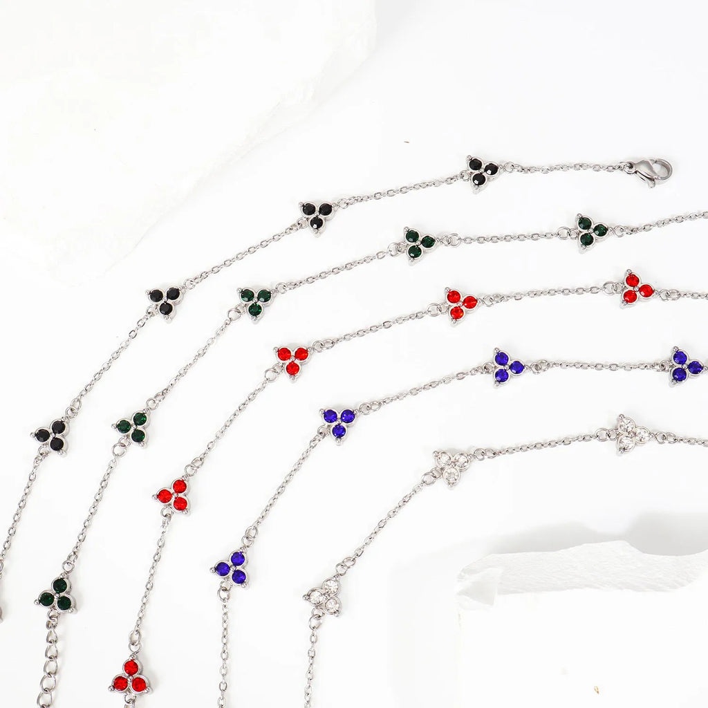 Women's stainless steel bracelet with three triangular charms set with coloured zircon stones.