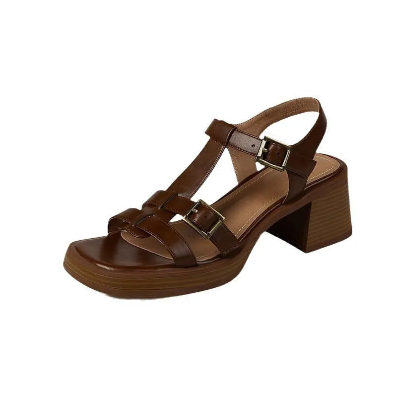 Black women's retro platform sandals with a T-buckle strap and chunky heel.