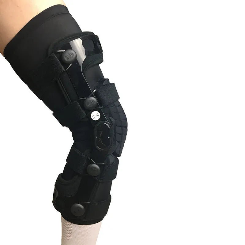Black adjustable anterior ligament knee support with straps, shown on a leg.