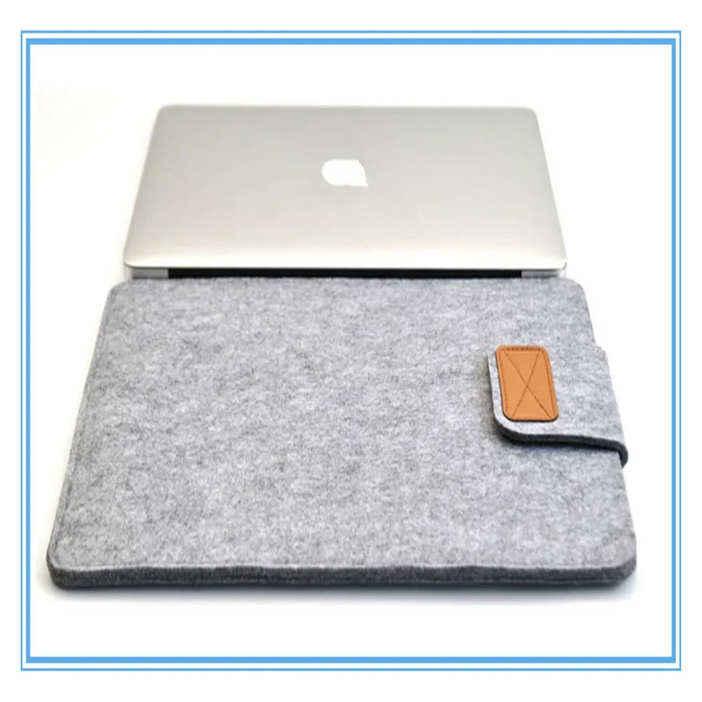 Dark grey clamshell laptop bag open to show interior laptop compartment and corner protector.