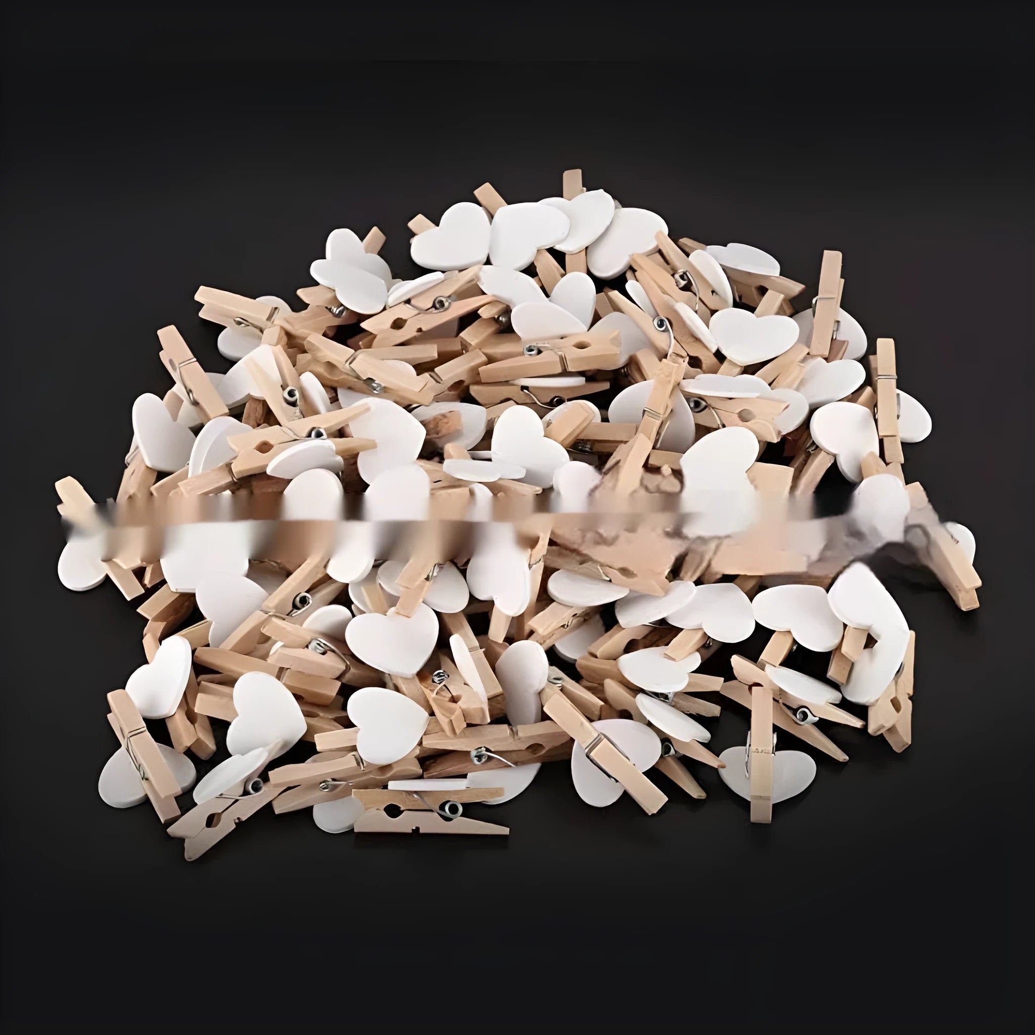 Five small solid wood heart-shaped clips in different colours showing handmade craft details