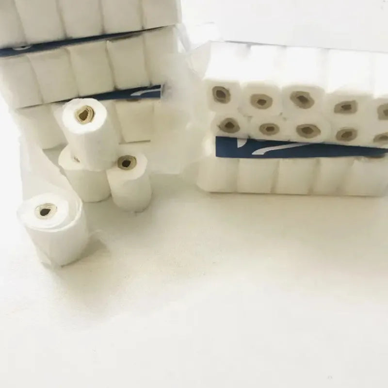 Small-scale simulated toilet paper roll model made of paper, shown next to a ruler for scale.
