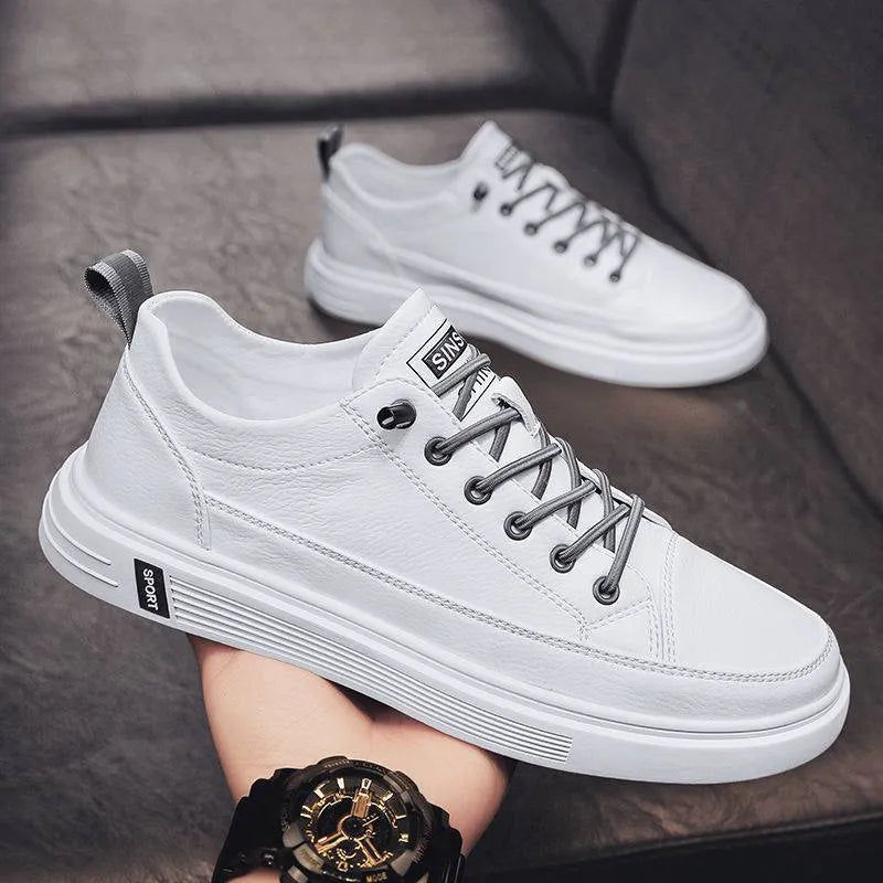 Men's white casual flat shoes with round toe and low heel on a plain background.