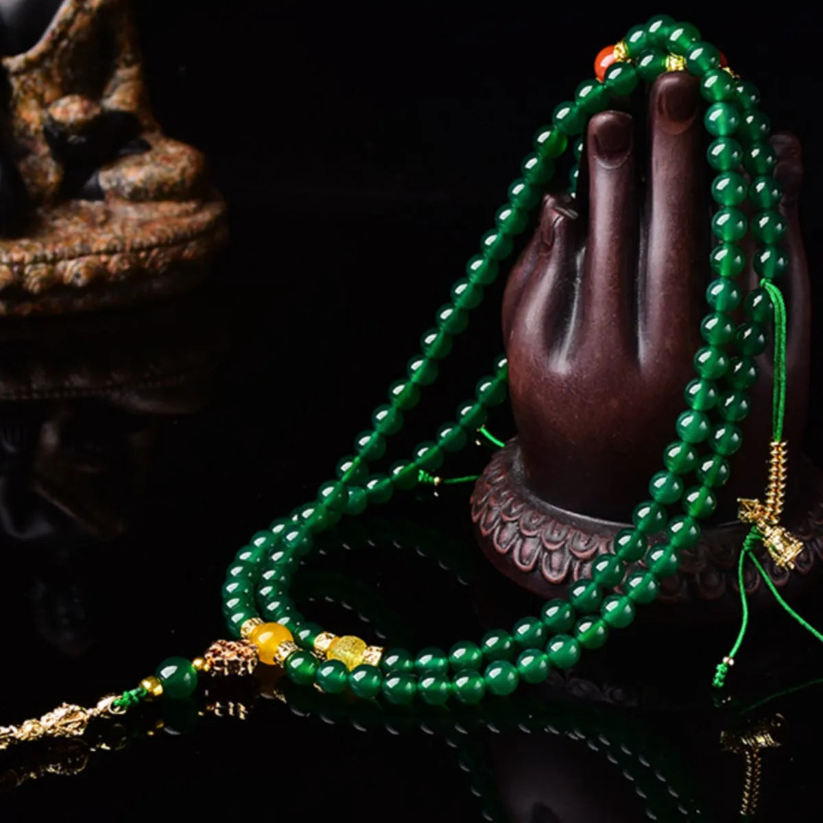 Natural green agate multi-strand bracelet with sliding knot closure on a wrist.