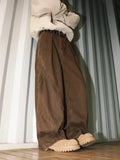 Men's pleated straight-leg trousers in apricot colour showing elasticated waistband detail.