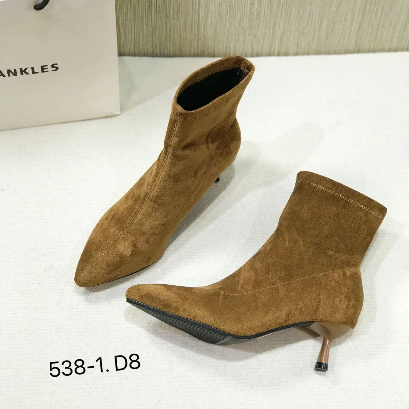 Women's black pointed toe ankle boots with stiletto heel and mid-calf height